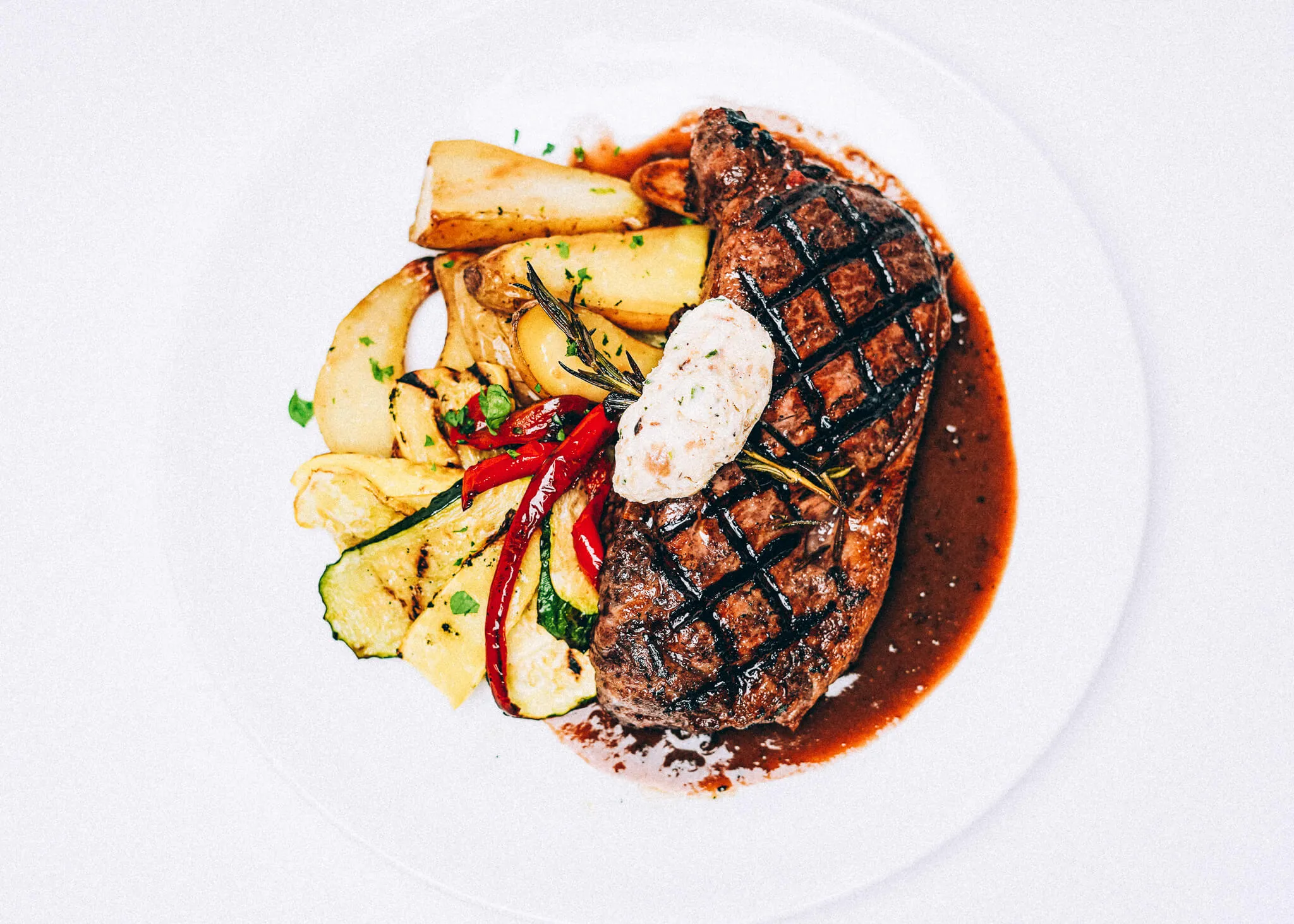 A plated steak dinner photographed for Café Whitney
