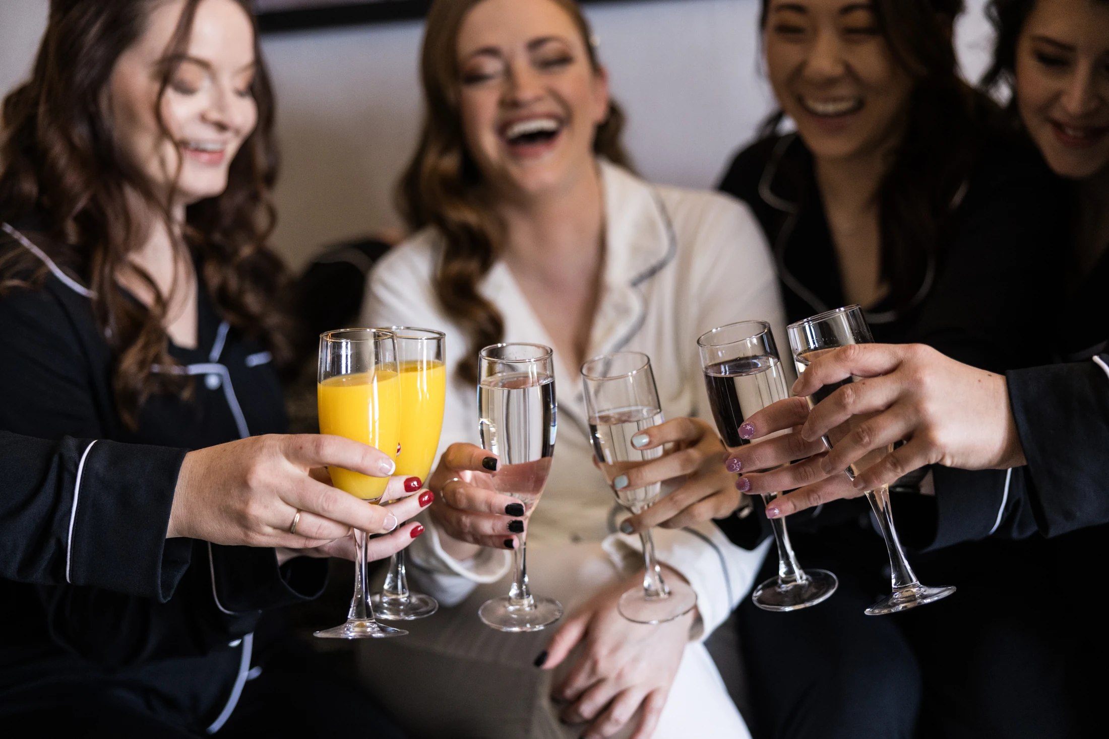 A bride and her friends sharing a toast while getting ready at Whitney Peak