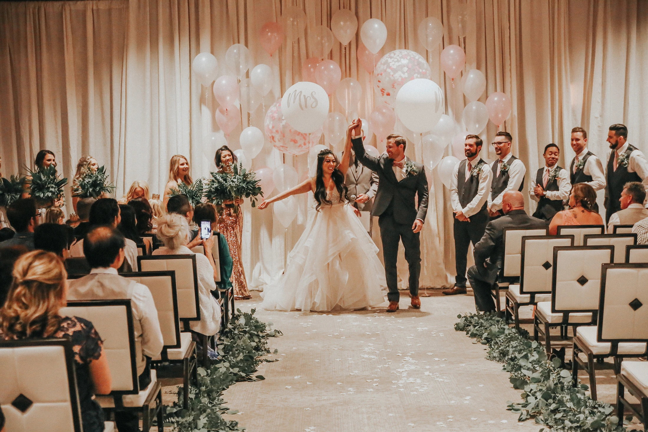 A newly married couple celebrating with their wedding party and seated guests at Whitney Peak