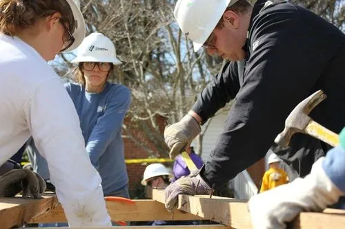 Construction workers cutting wood