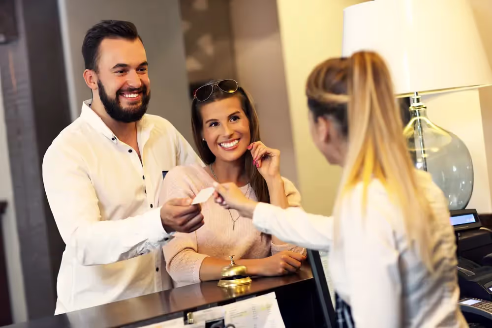 Businessman checking in to hotel with wife