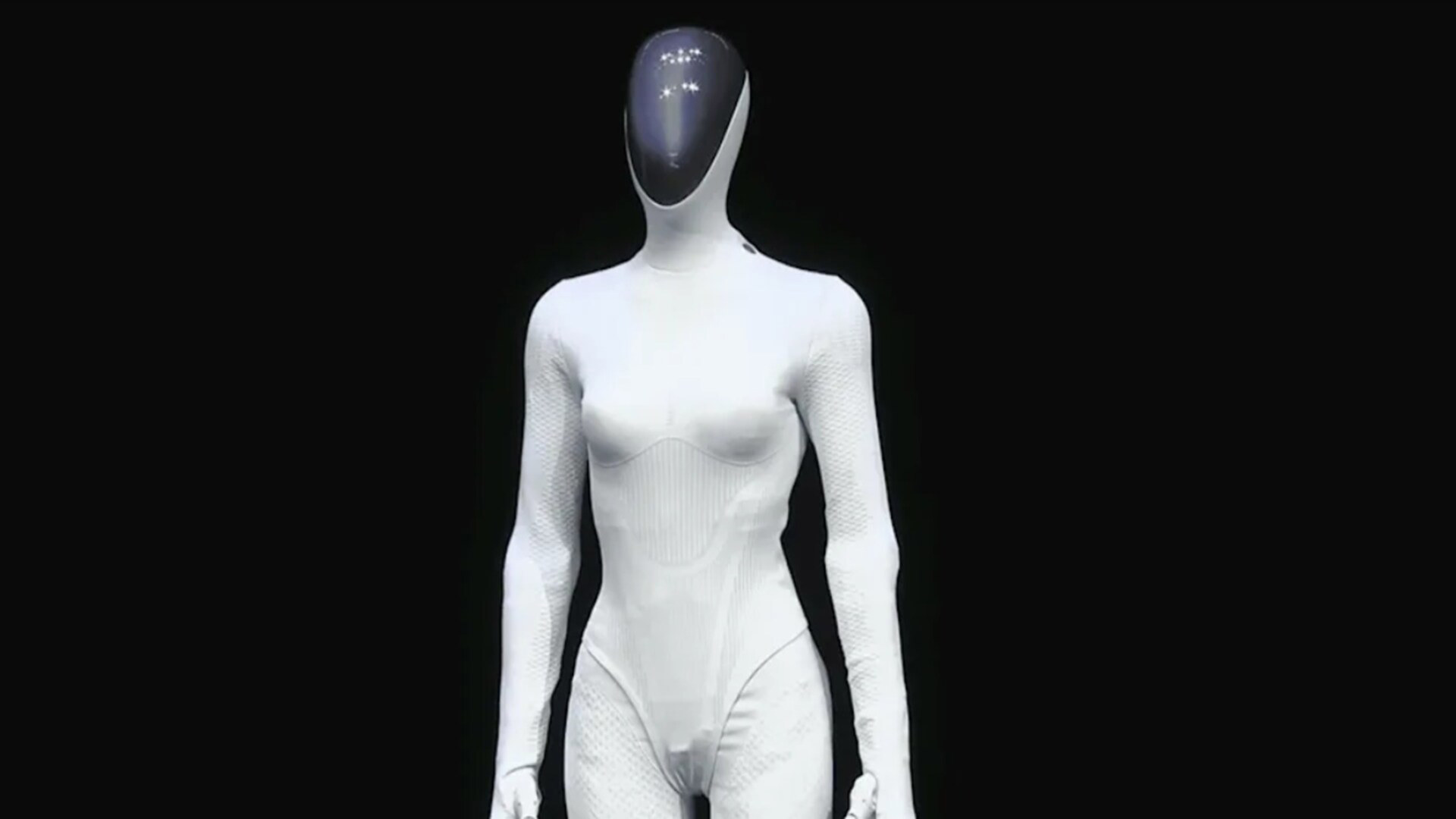 XPENG IRON humanoid robot standing front-on, showing its white synthetic-skin body and dark visor head