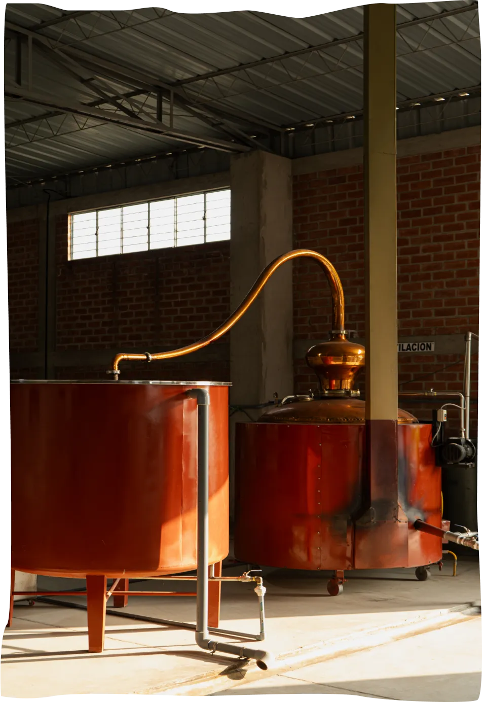 A room filled with lots of red barrels next to a brick wall.