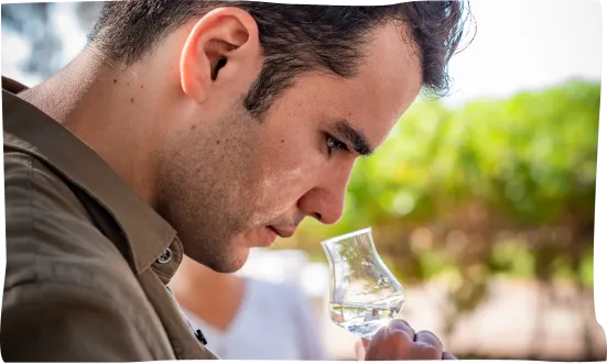 A man holding a glass of water in his hand.