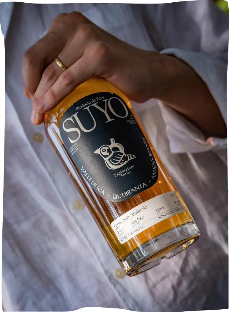 A person holding a bottle of suyo.