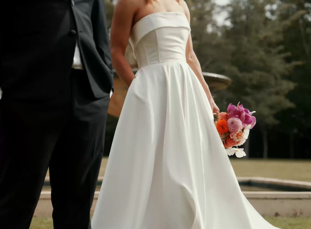 Bride and groom holding hands in a garden