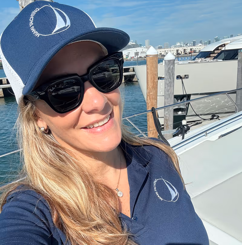 Karina Smith on the foredeck of a docked motor yacht ready to set sail.