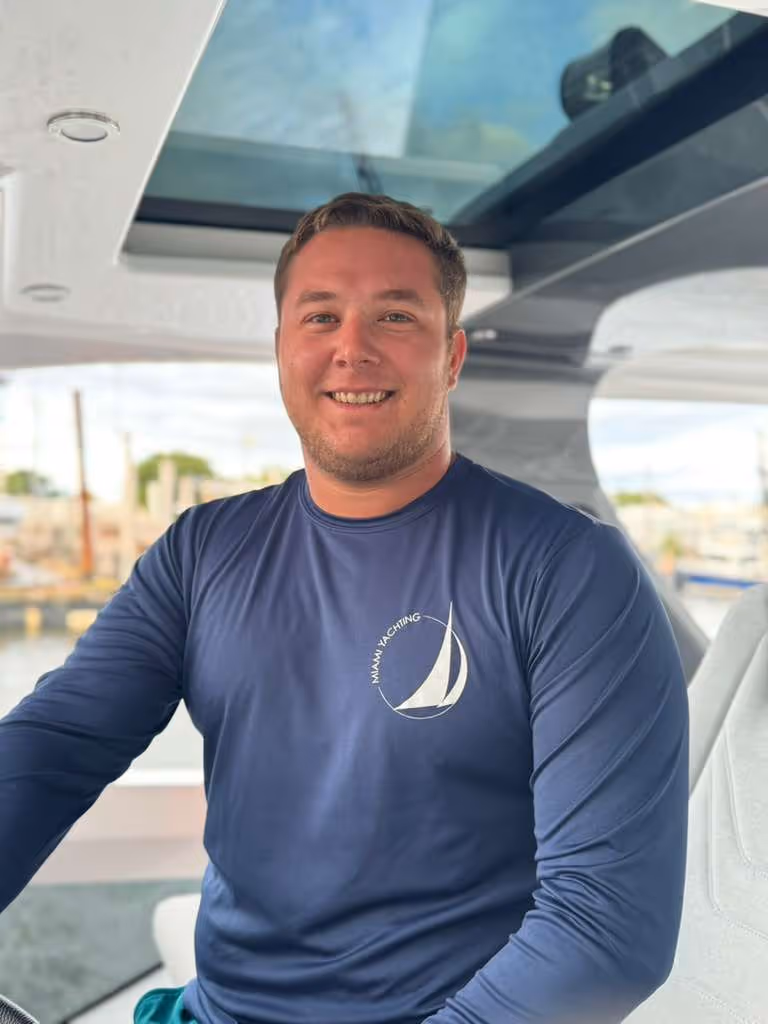 Capt. Alejandro Molero at the helm of a motor yacht while docked.