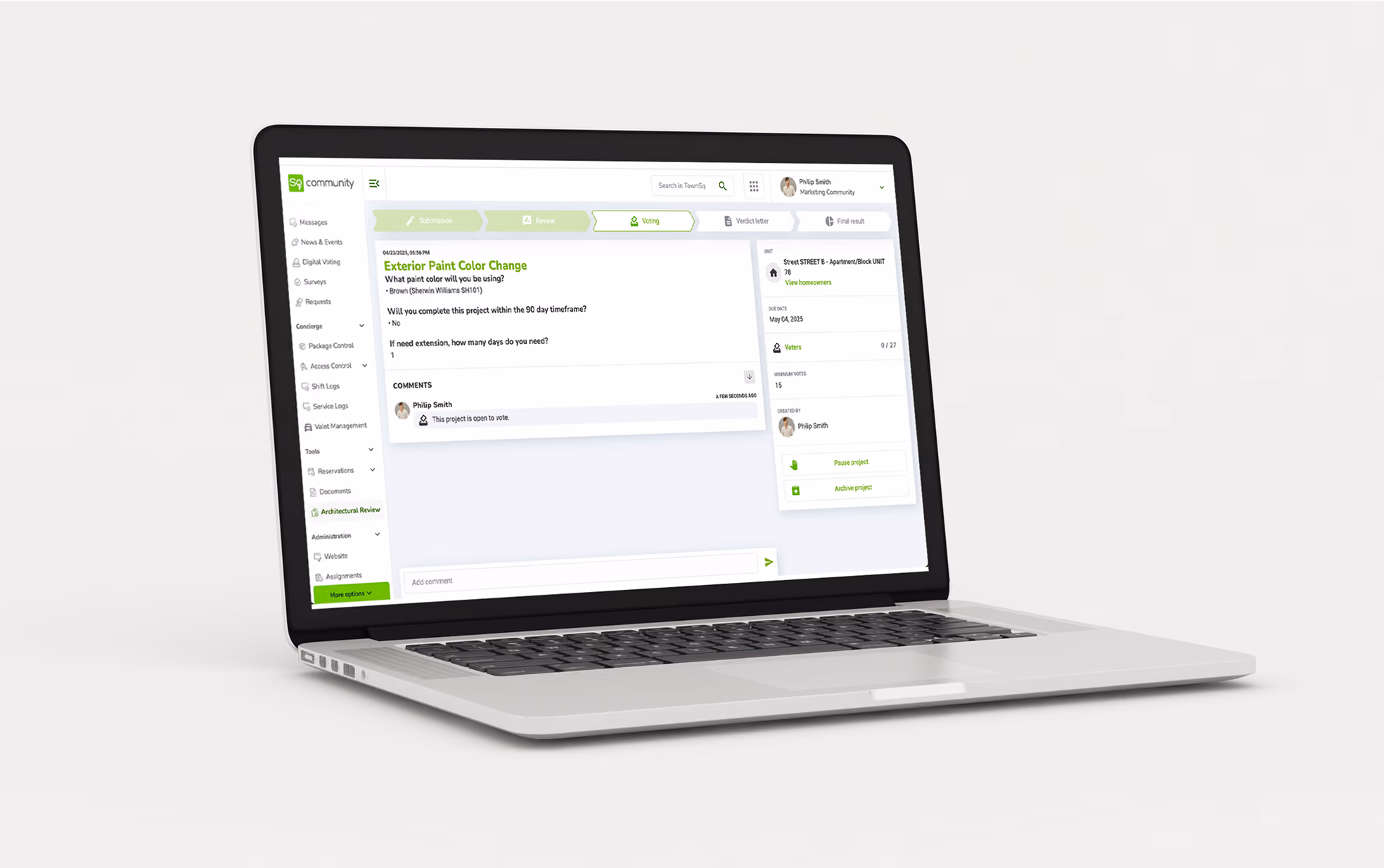Laptop displaying architectural review voting process in community management software.