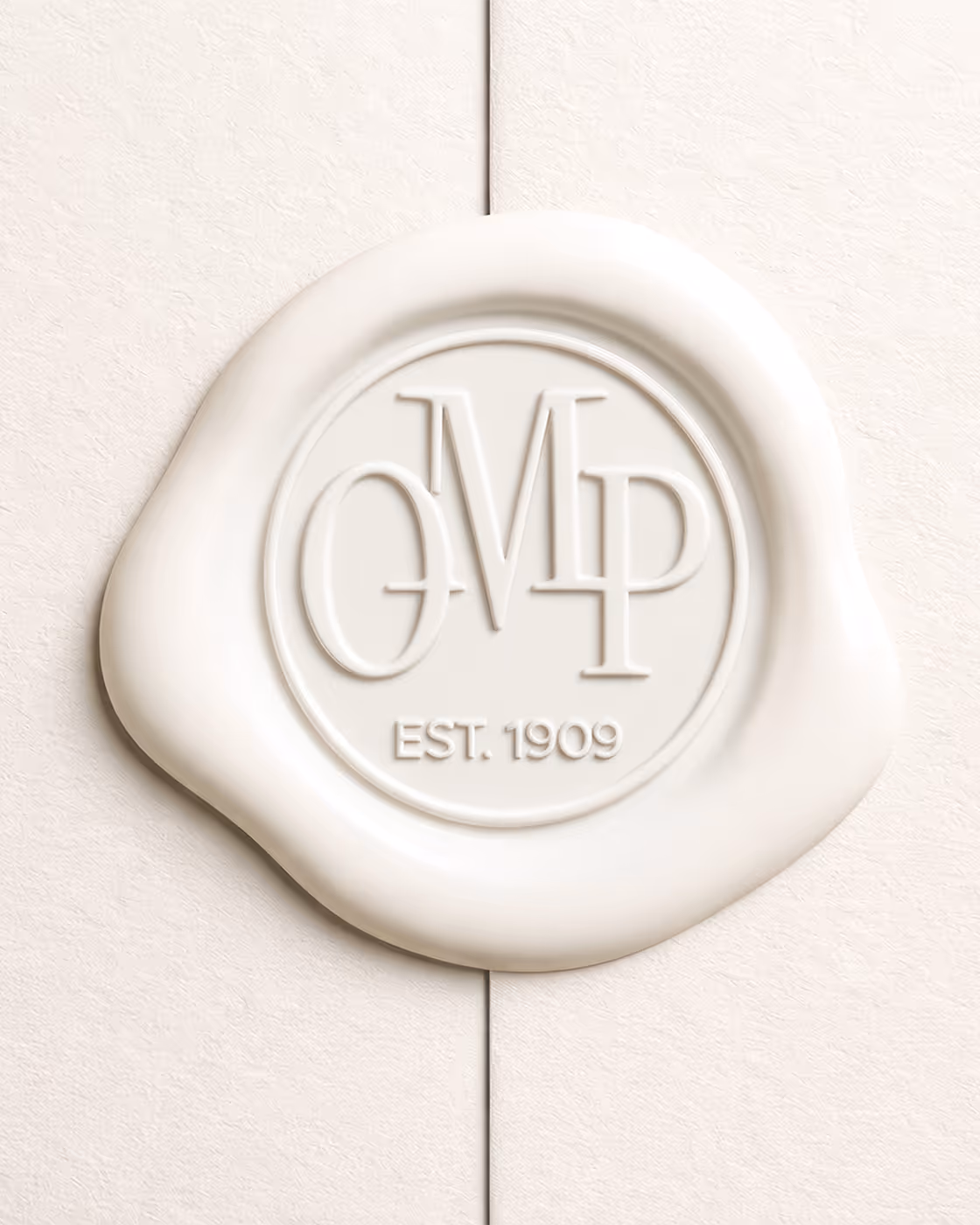White wax seal with embossed Otto Mønsted Plads logo mark on a textured cream paper background.