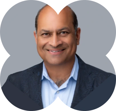 A man in a suit smiling for a picture.