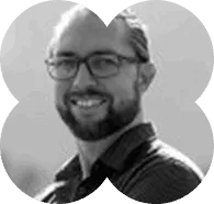 A black and white photo of a man with glasses.