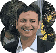 A man in a suit smiling for a picture.