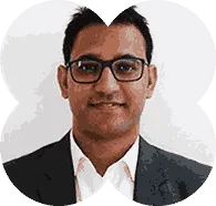 A man wearing glasses and a suit.