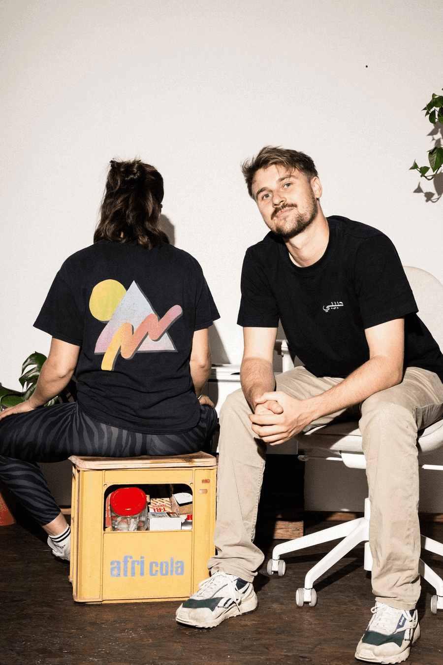 Lisanne und Tobi im Studio, Lisanne sitzt auf einer Getränkekiste und dreht sich um