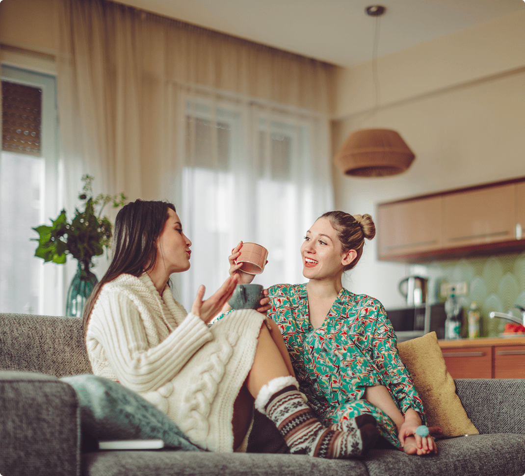 Two friends relaxing and catching up in the living room