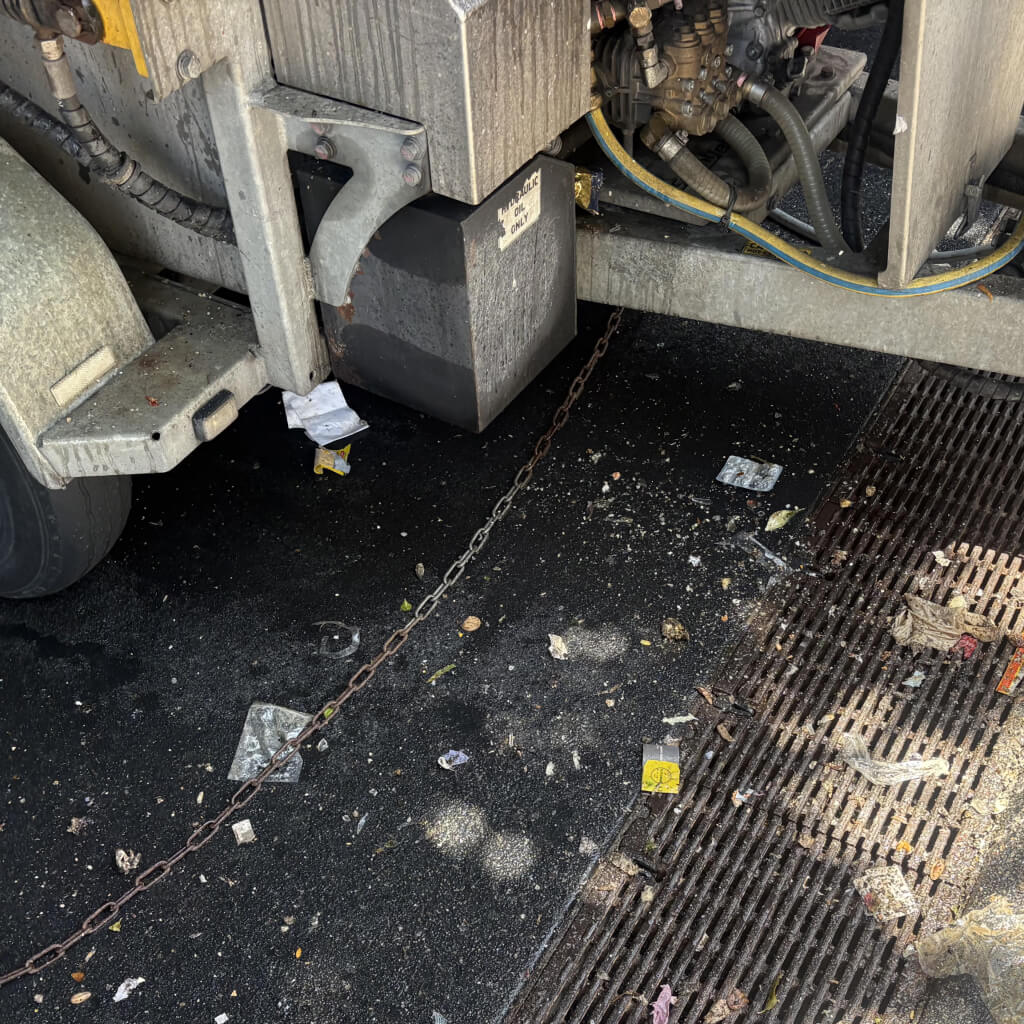 close up of garbage spilled onto ground due to no shield on the gold coast bin butlers trailer