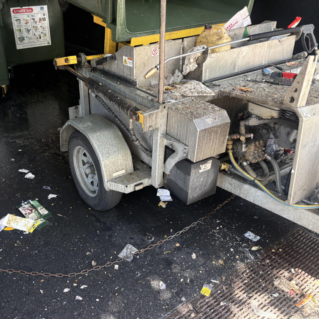 displaying overspray and muck spilled all over the machine due to no rear cover or shield