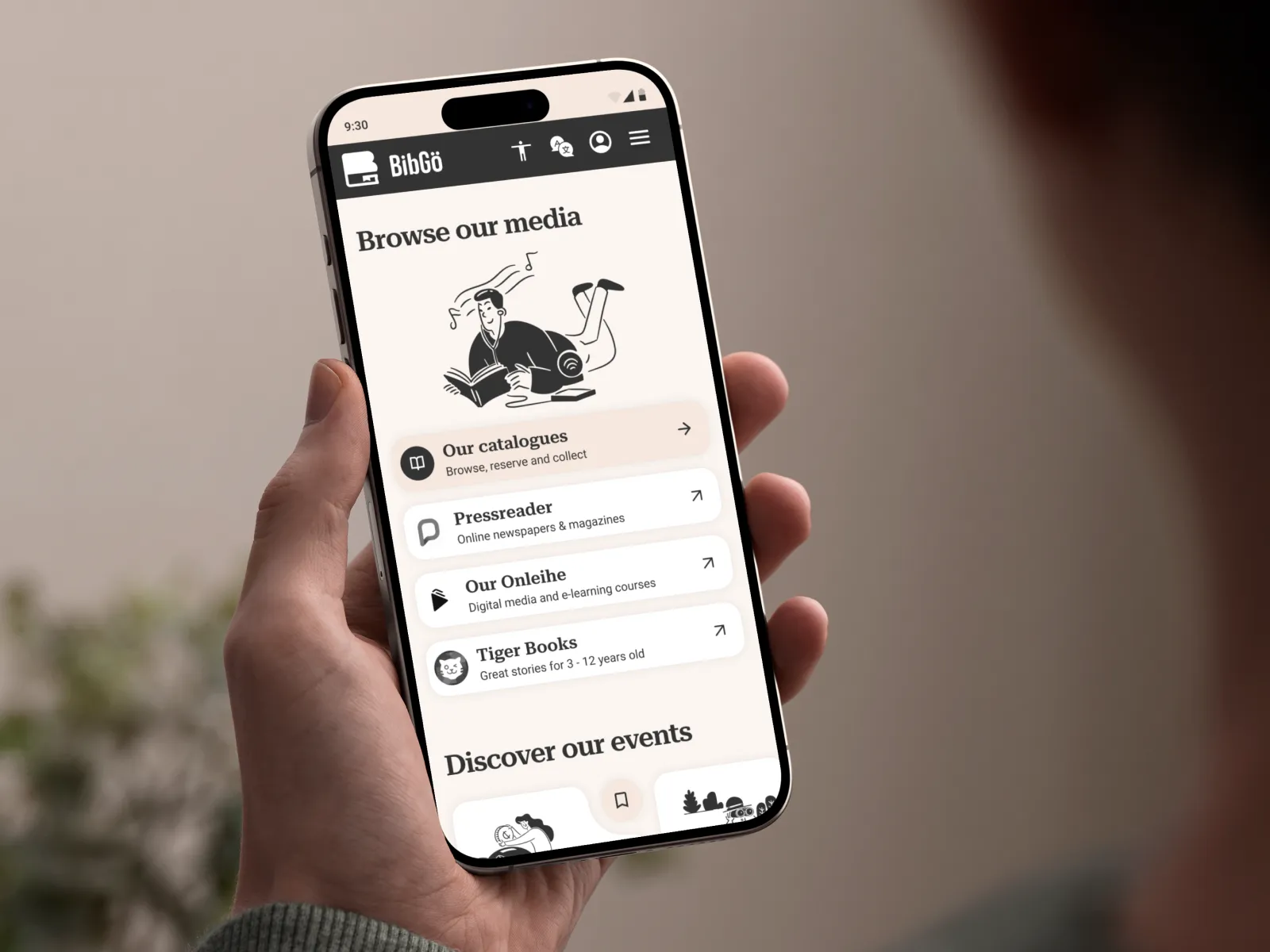 Design mockup; Hand holding smartphone showing the 'browse media' section of the BibGö homepage.