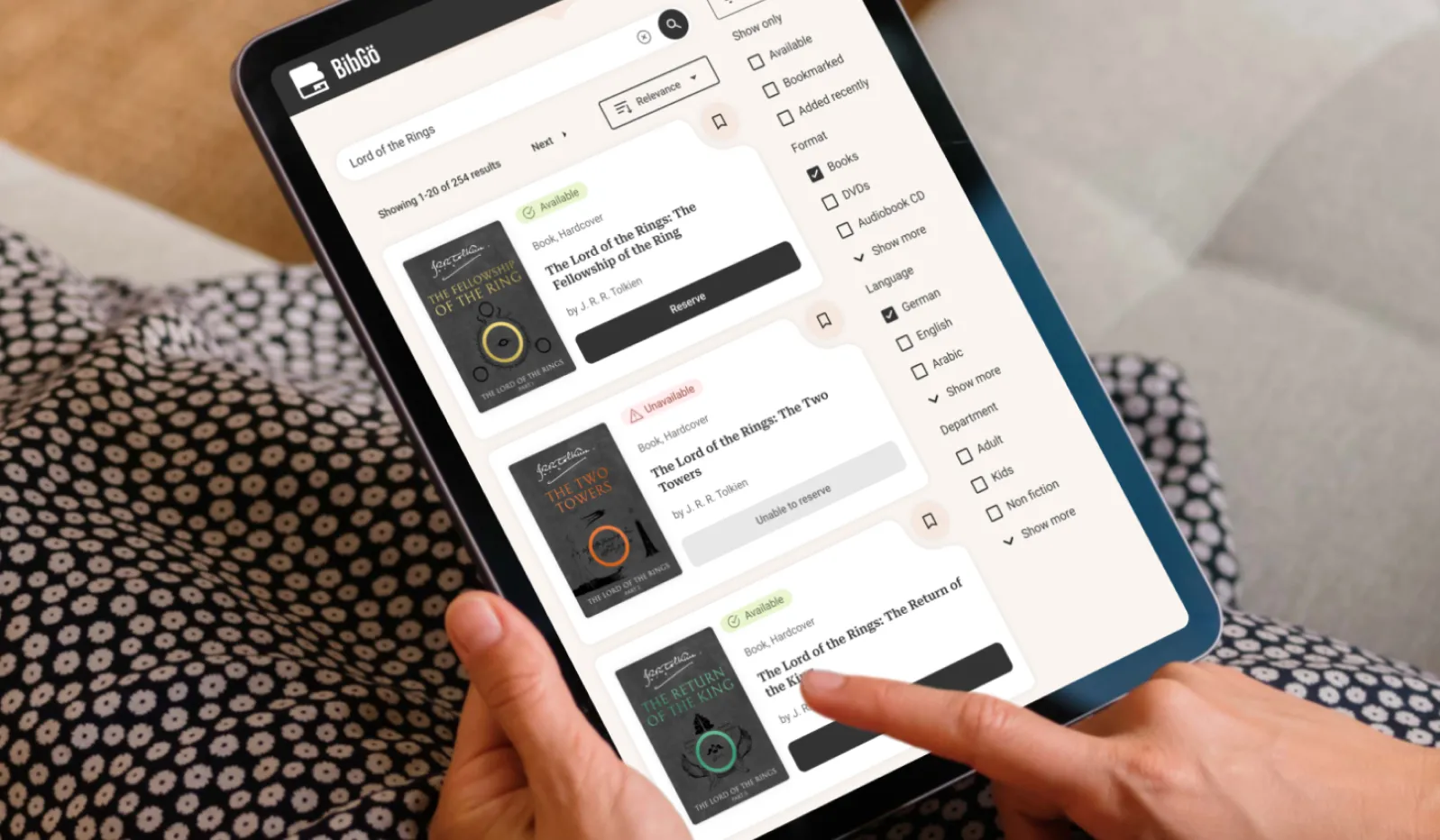 Tablet mockup screen showing BibGö's search results for 'Lord of the Rings'.