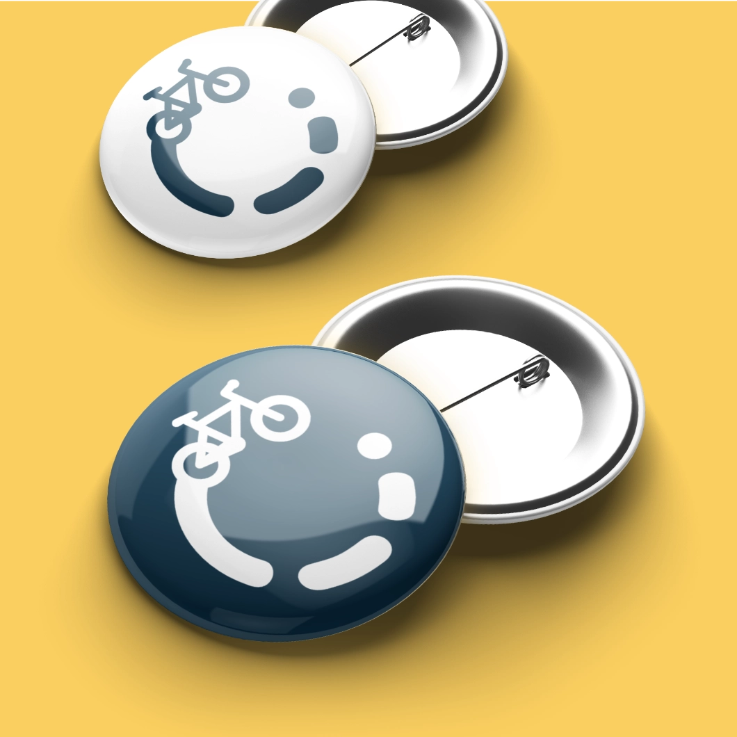 Two round pin-back buttons featuring the 'Get Somerset Cycling' logo.