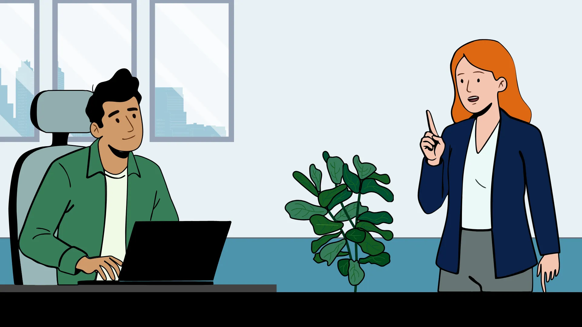 Hamza sitting at his desk working on a laptop while Julia stands nearby, speaking and gesturing with her finger raised.
