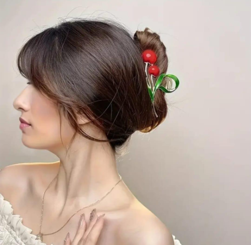 Gold cherry hair clip with red berries and green leaves for Y2K-inspired hairstyles.