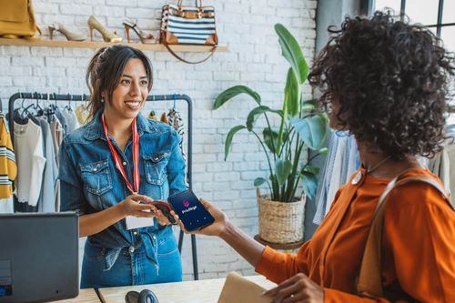 Customer at clothing store using their mobile device to get a discount