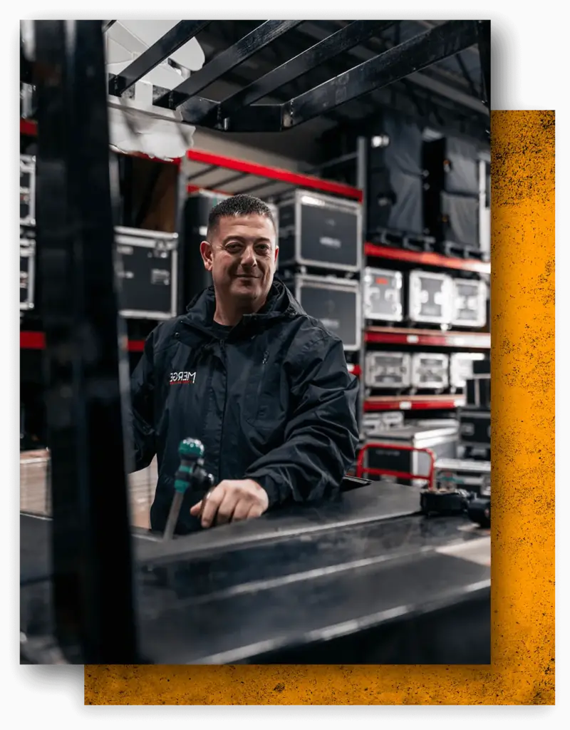 Massimo DiDonna at a mixing desk in a production warehouse