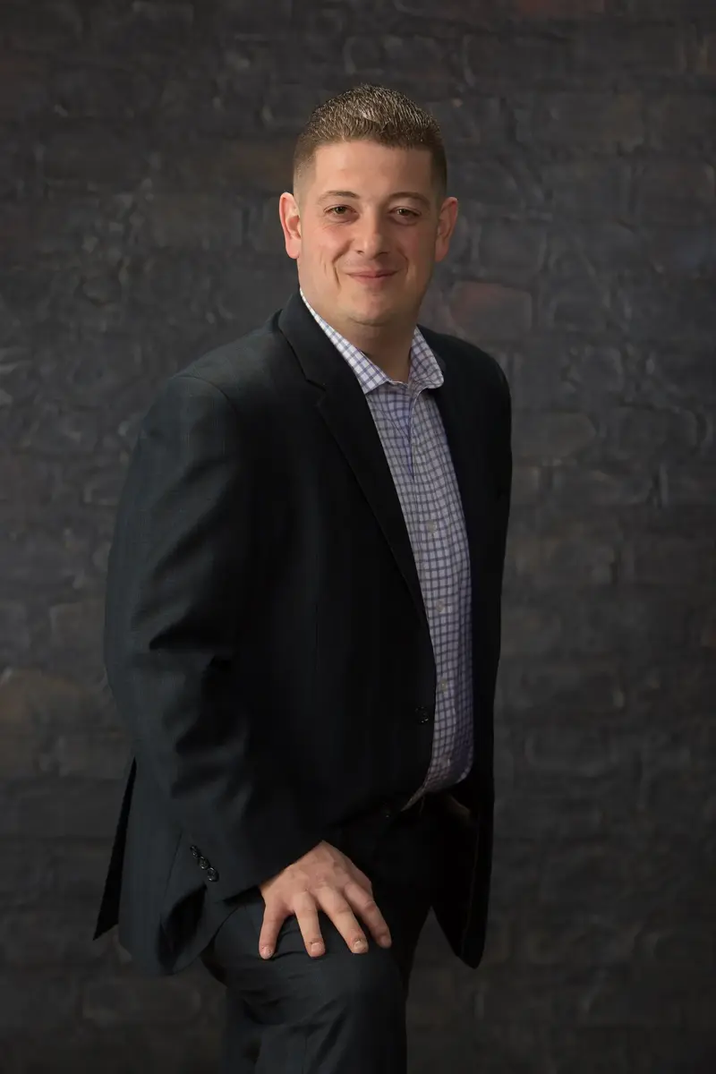 Massimo DiDonna standing in a dark suit