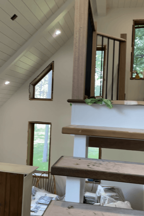 Finishing Touches: Skilled Worker Installs Trim for Flooring at Door Entrance