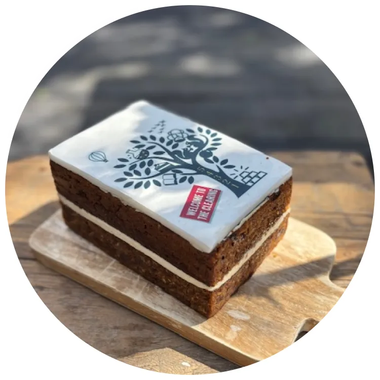 Layered cake with The Good Listening To Show tree design on white frosting