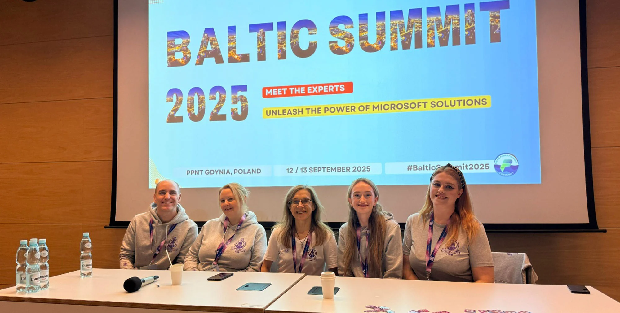 A team of five sat in front of a Baltic Summit projection.
