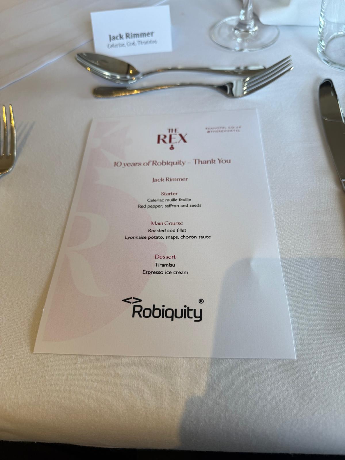 Photo of menu in between dinner place setting 