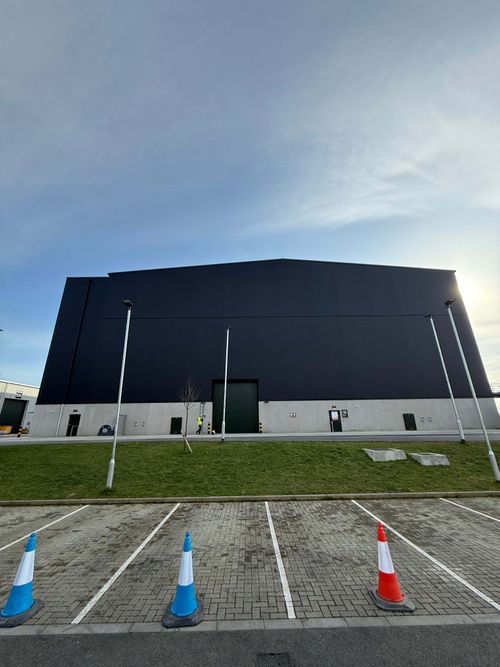 Before and after transformation of cladding respraying on a commercial building exterior