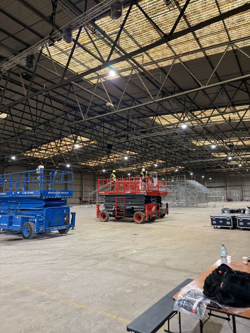 Protective weather-resistant coating being sprayed onto metal cladding for long-term durability