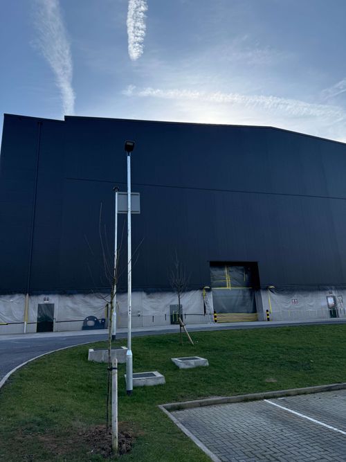 Spray painting the exterior of Shepperton Studios using airless spray technology.