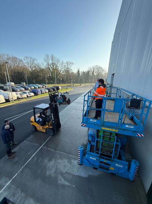 Before and after comparison of cladding repainting at Shepperton Studios.