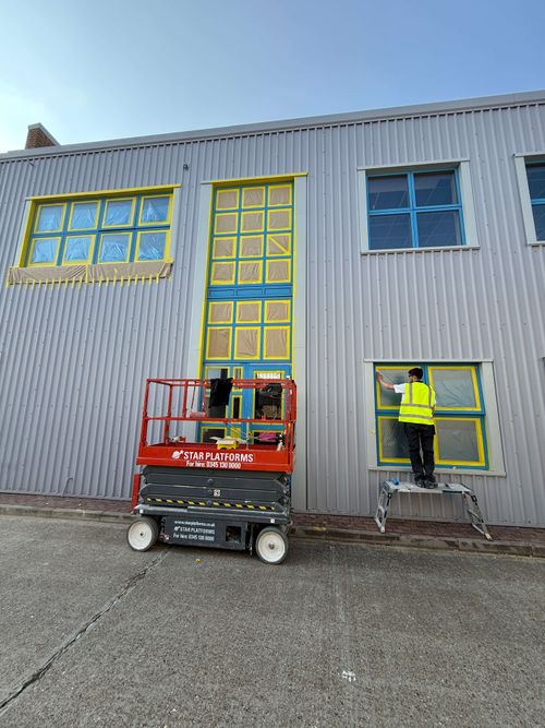 Final prep stage with all masking in place across commercial facade.