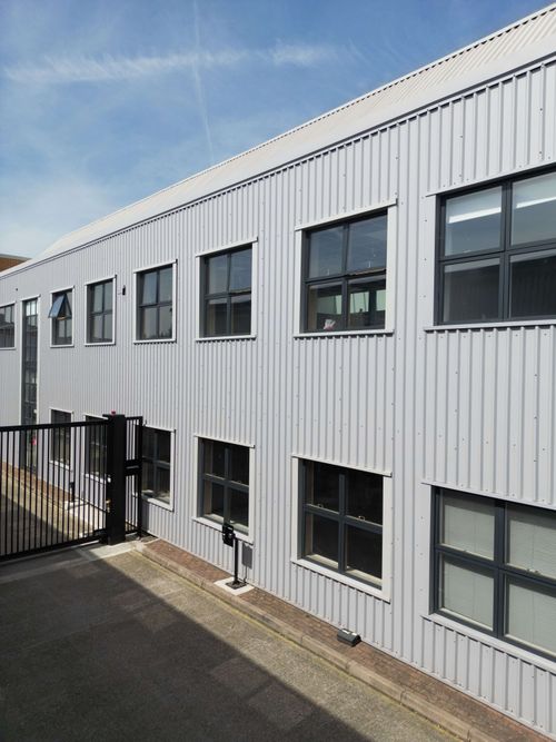 Entire facade with all frames masked evenly across multiple levels.