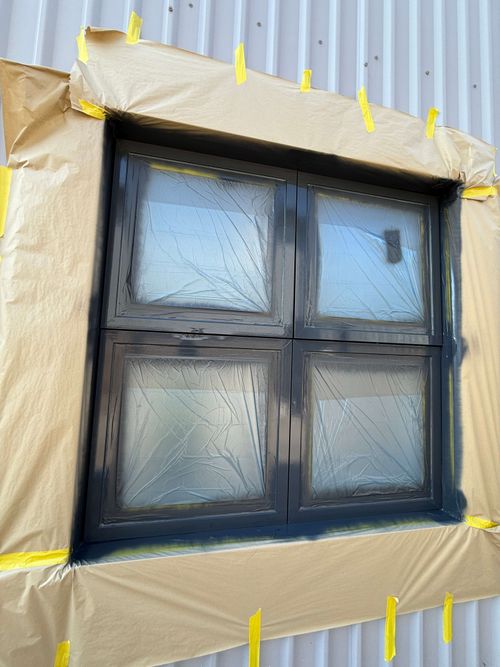 Drone view of full building with window frames prepped for paint.