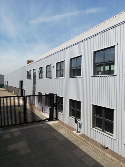 Mid-level view of multiple windows masked for commercial spray painting.