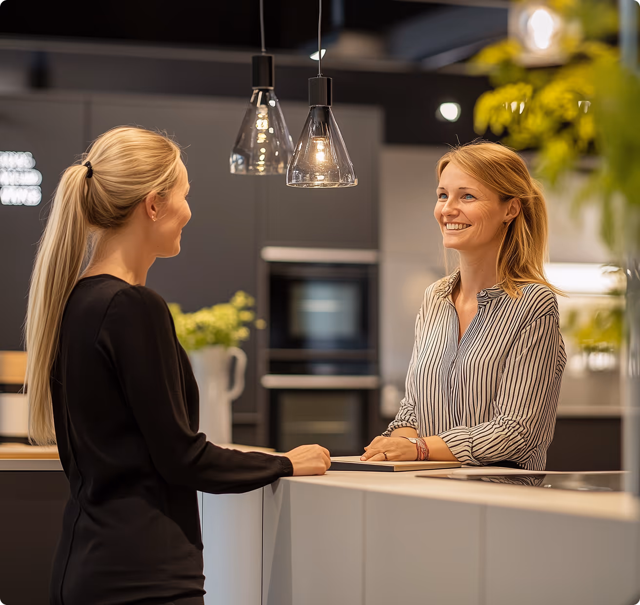 photo of two people talking together in a kitchen