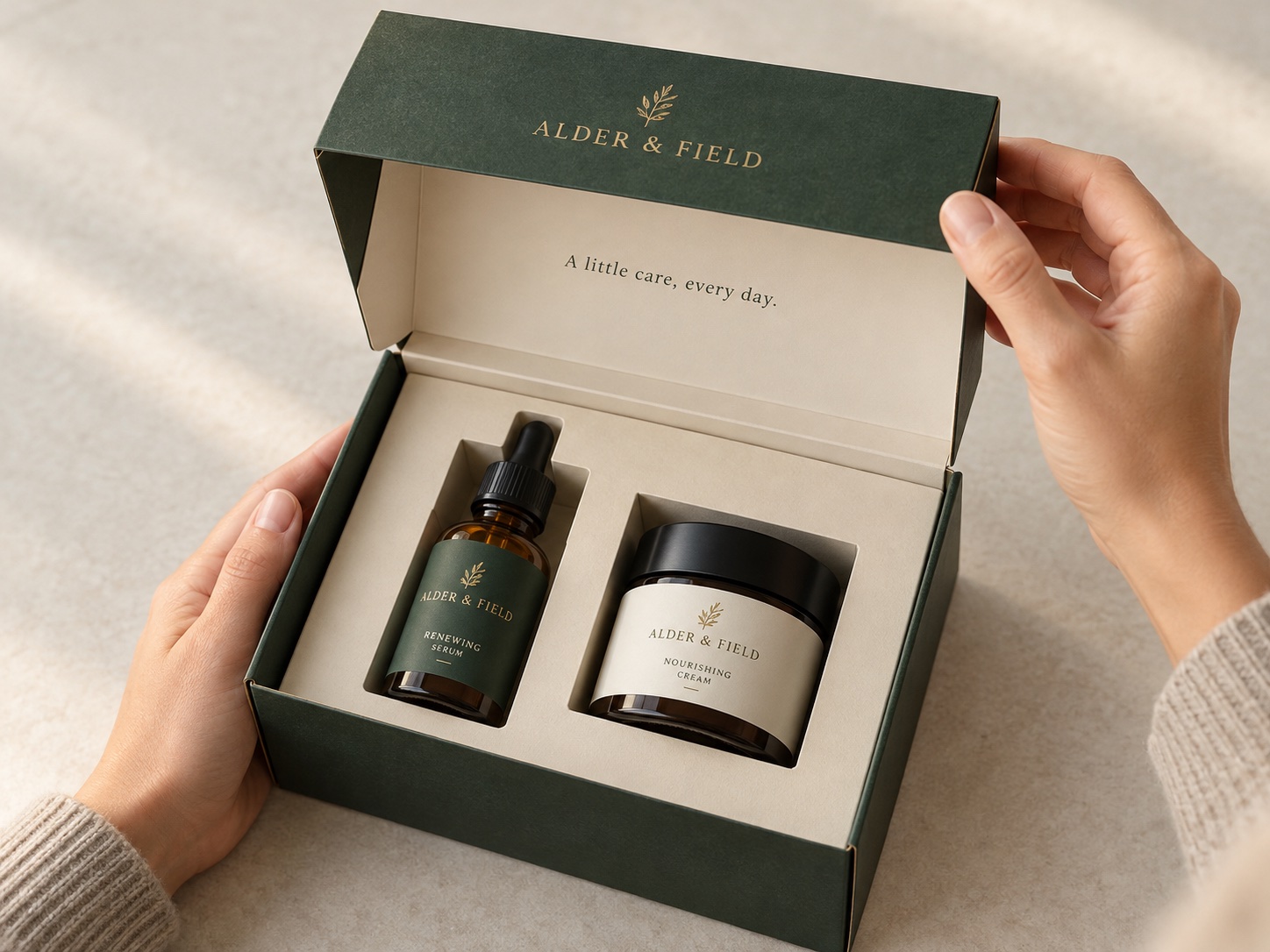 Hands opening a skincare gift carton with interior printing and fitted insert