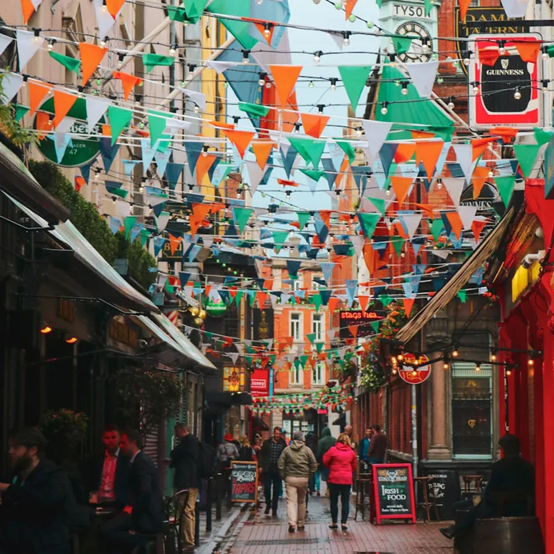 A Dublin street with strings of Irish flags connected across each building