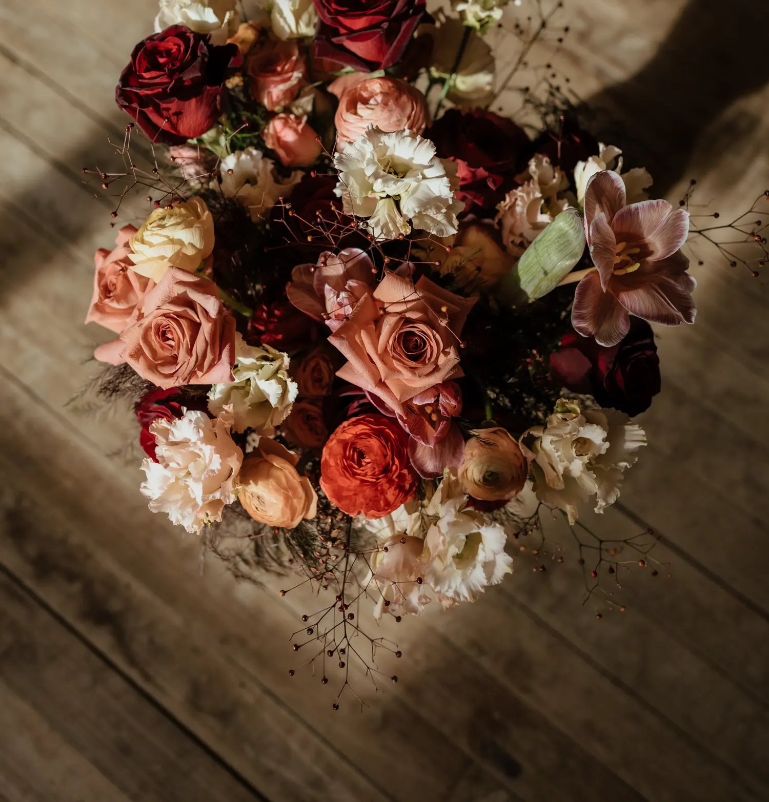 a bouquet of flowers against original hardwood floor