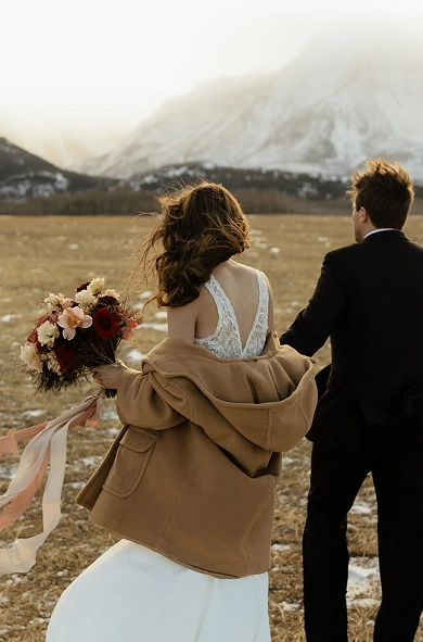couple eloping in Waterton with mountain backdrop