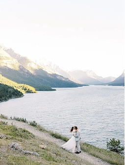 Wedding photo of couple in front of Waterton Lake