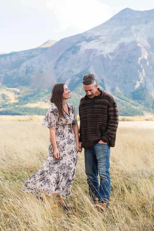 photo of Pam and Derrick Heggie who are the founders of Freddy's on Main the photo was taken in Waterton with a mountain backdrop
