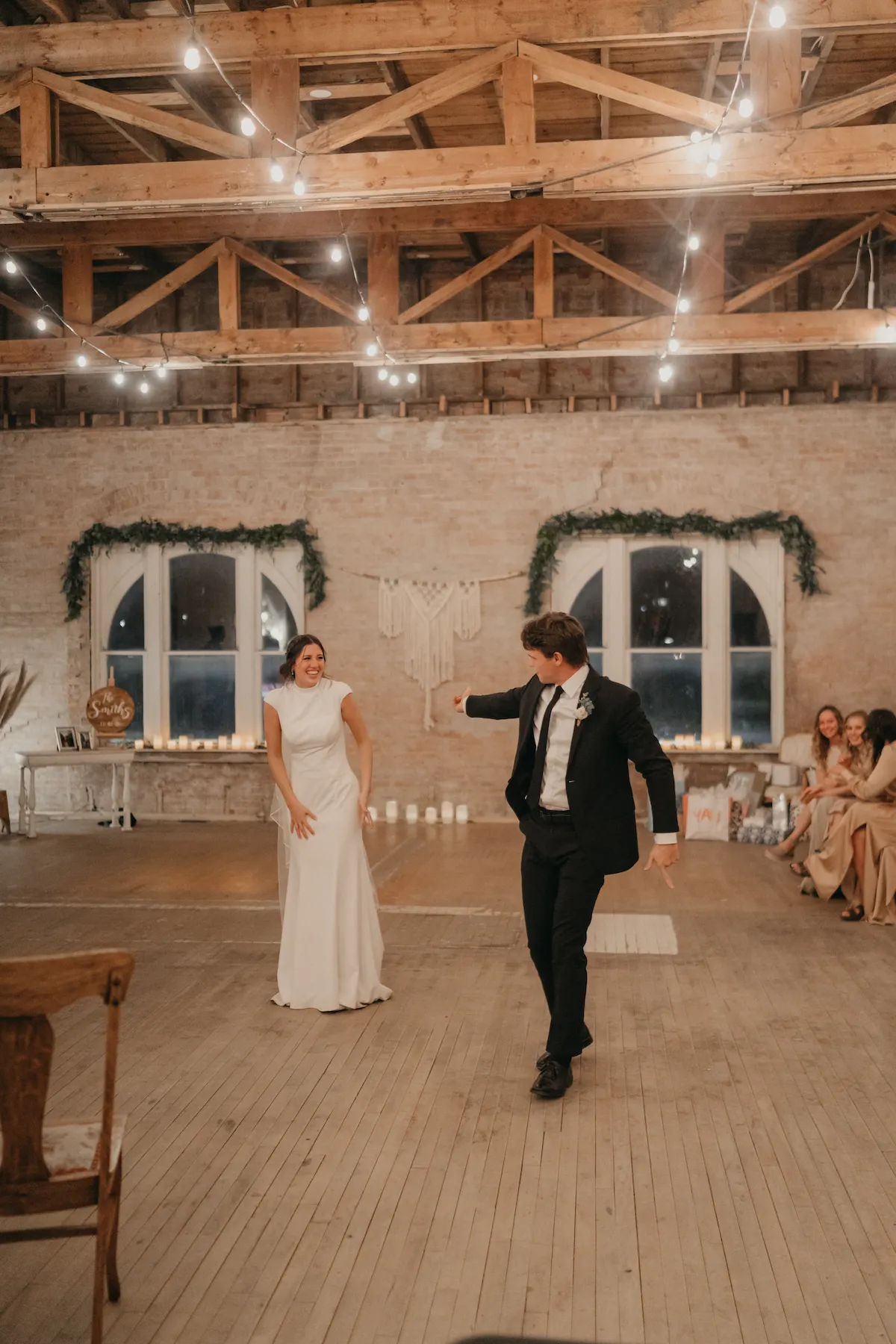 groom inviting bride to the dance floor